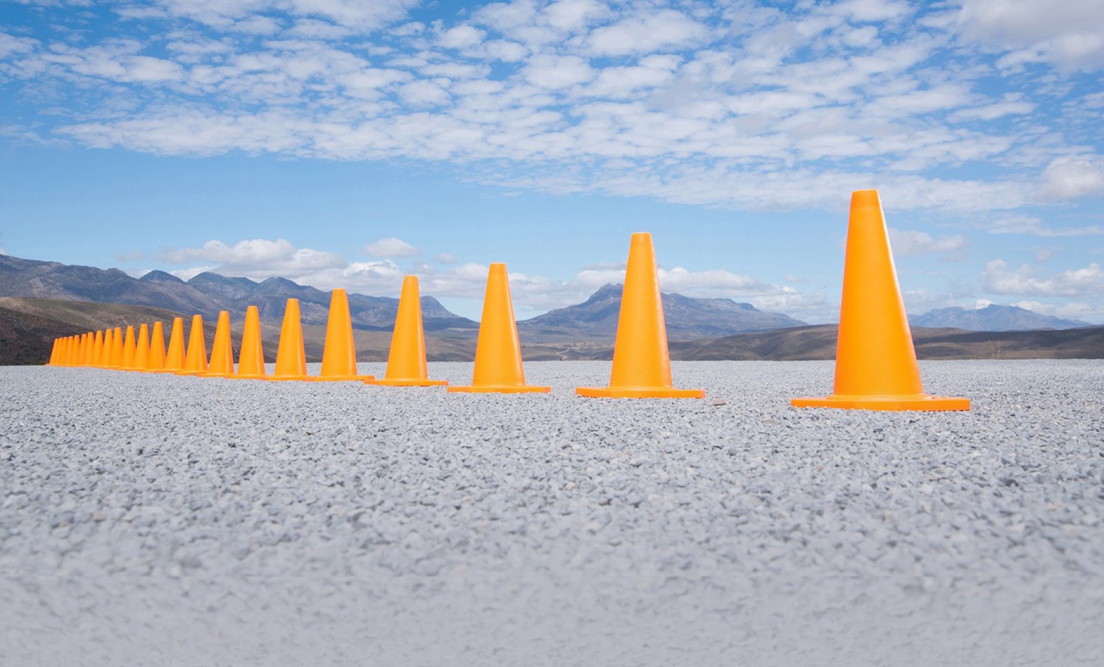A line of traffic cones across an open plain